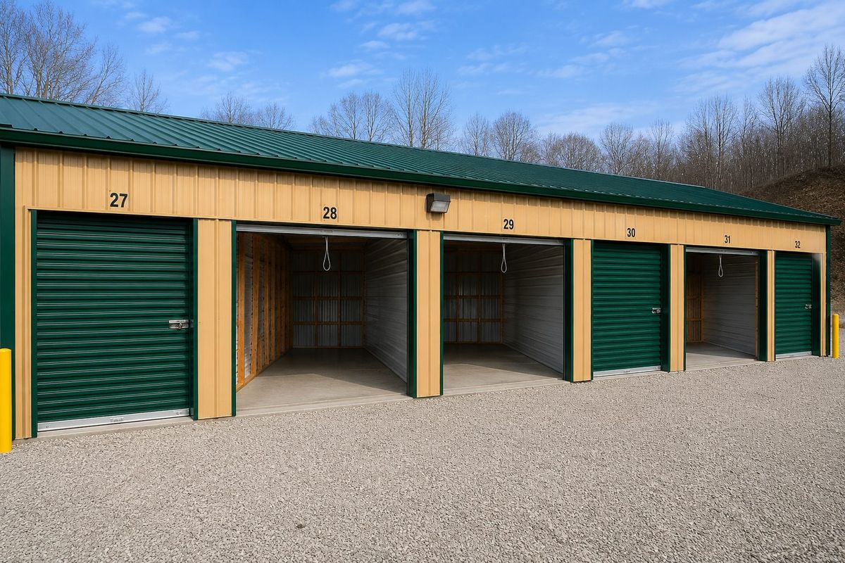 A row of storage units 27 through 32 with several open doors revealing clean concrete floors and wood-framed interiors